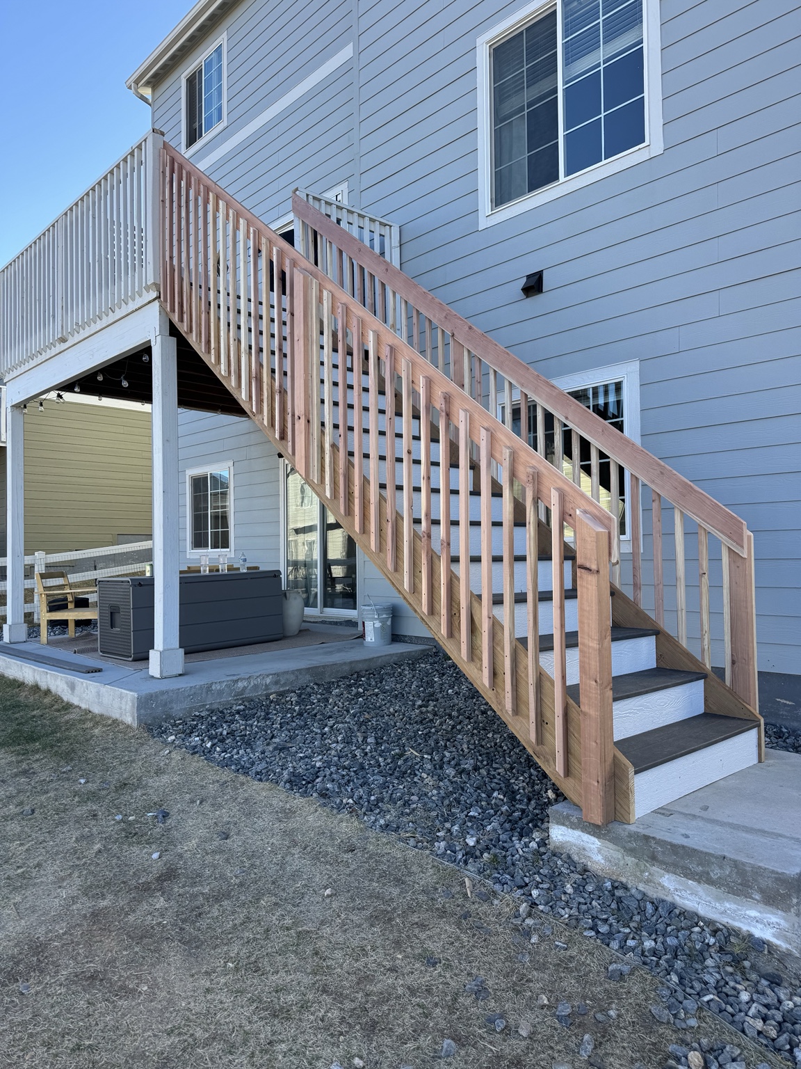 Exterior deck stairs beside gray siding