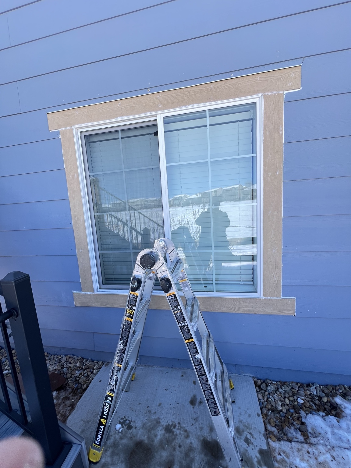 Residential window with finished white frame and exterior trim